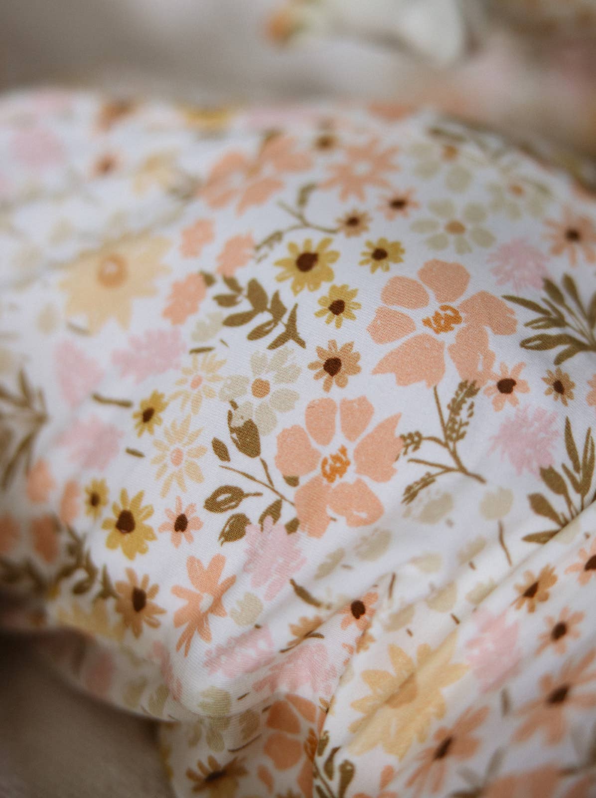 Floral patterned fabric with pink, orange, and green flowers on a white background