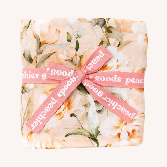 Floral-patterned product wrapped with a pink ribbon and 'Peace & Good' text on a white background