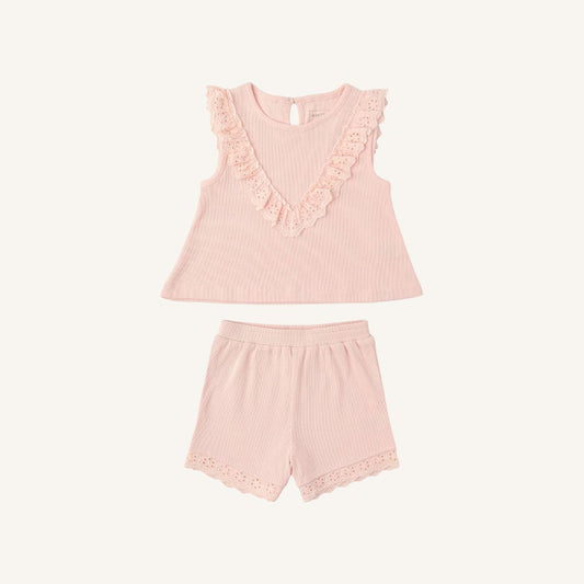 A two-piece baby girl's loungewear set in light pink ribbed fabric, featuring a sleeveless top with a V-neck and lace trim, paired with matching shorts with lace hem.