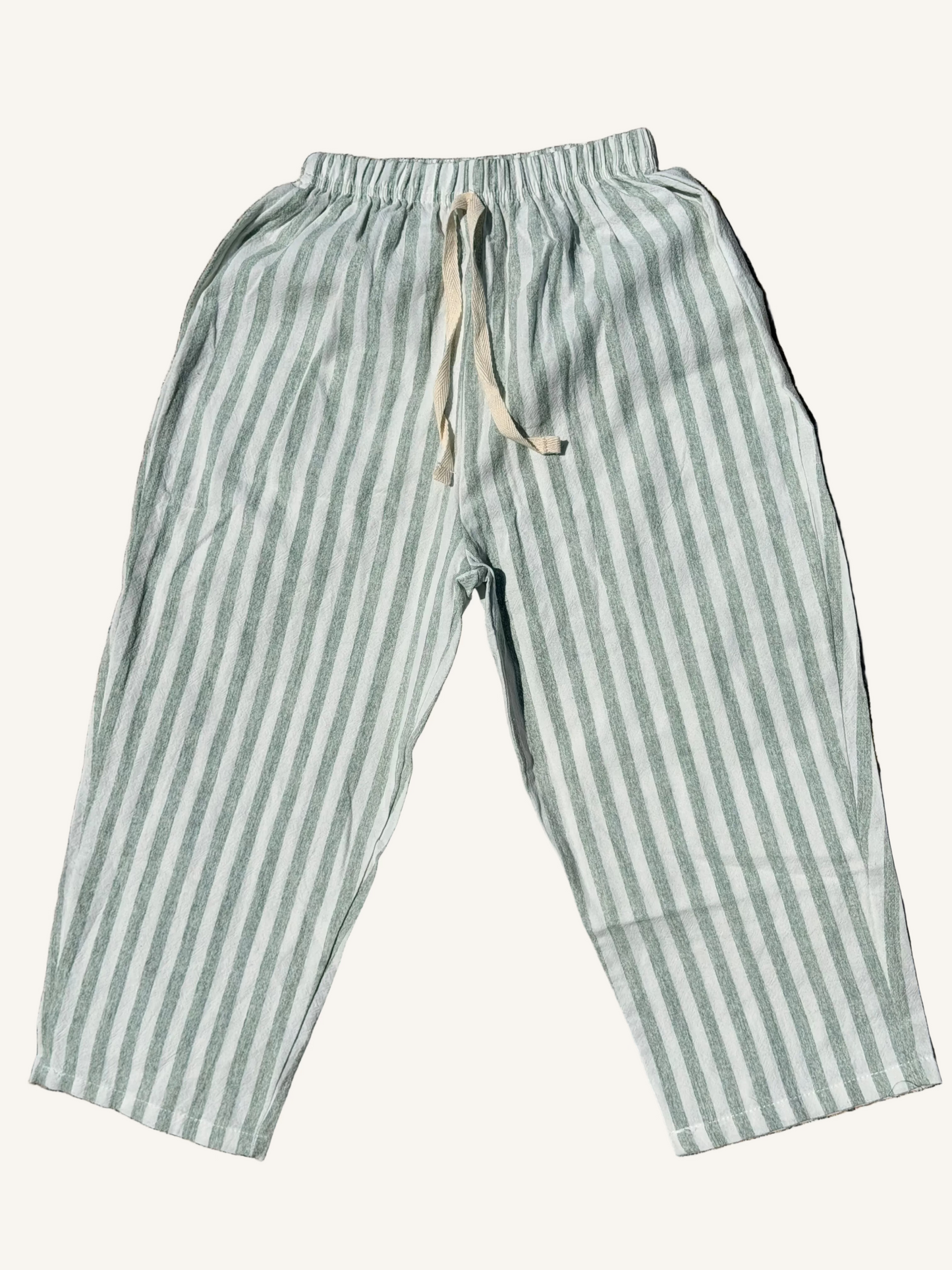 sage stripped pants with a neutral background

