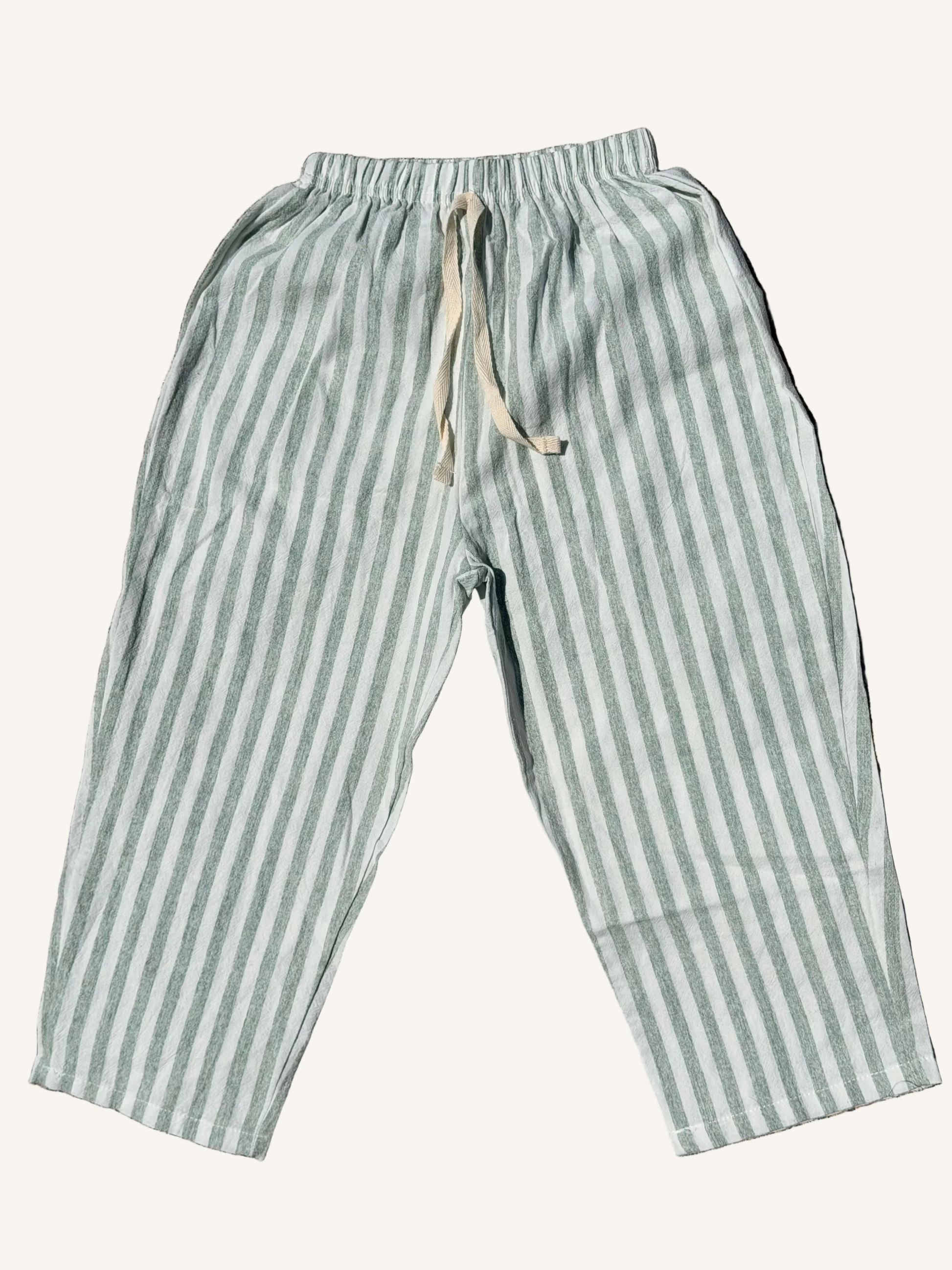 sage stripped pants with a neutral background

