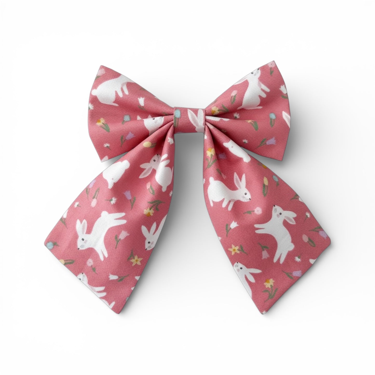 Pink bow with white rabbit pattern on a white background
