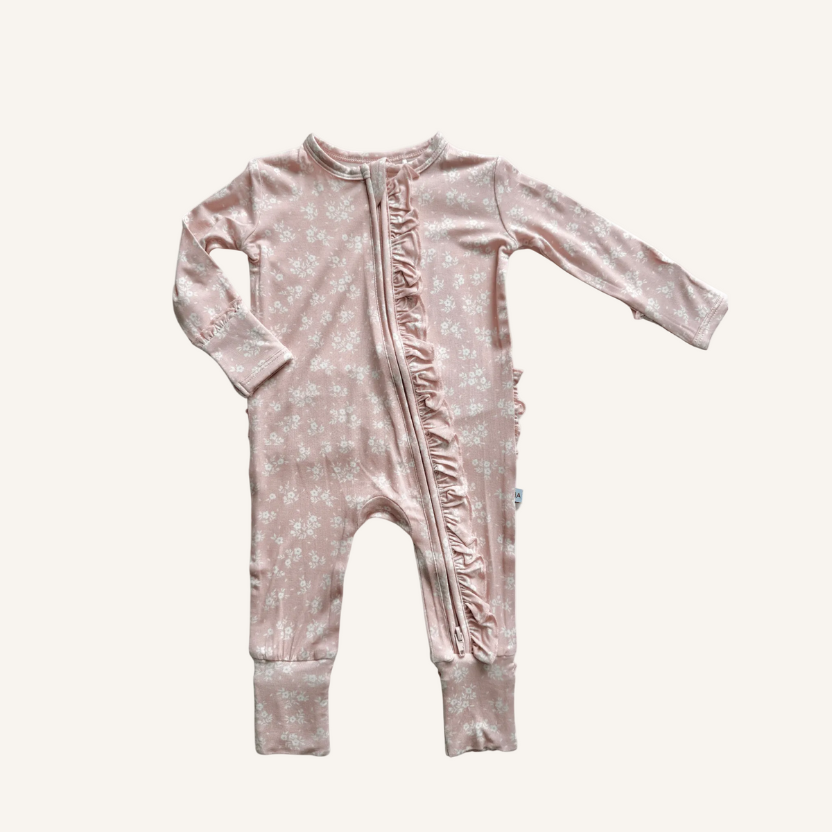 Pink baby onesie with floral pattern on a white background