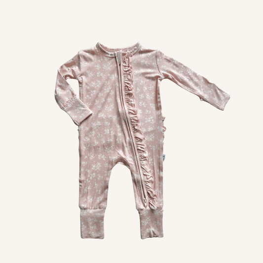 Pink baby onesie with floral pattern on a white background